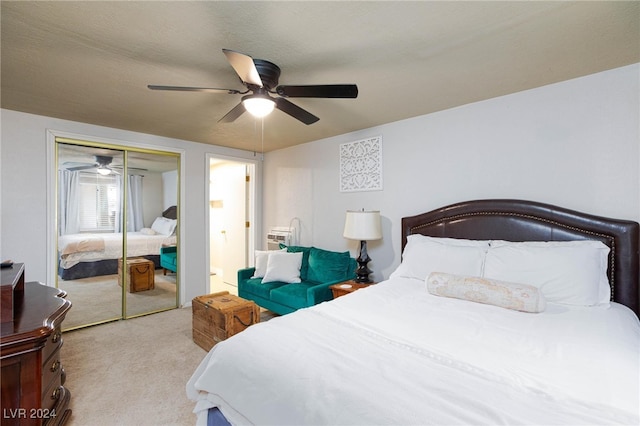 carpeted bedroom with ceiling fan, a closet, and a textured ceiling