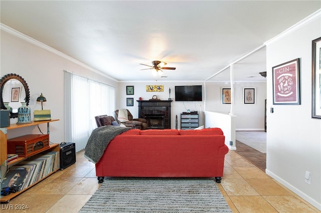 living room featuring ceiling fan, crown molding, and light tile patterned floors