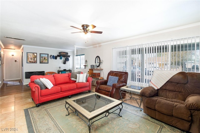 living room with tile patterned flooring, ceiling fan, and crown molding