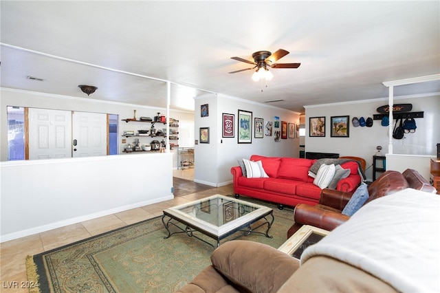 living room with ceiling fan, light tile patterned floors, and crown molding