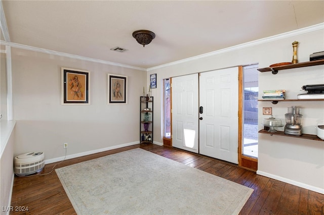 foyer featuring crown molding and dark hardwood / wood-style floors