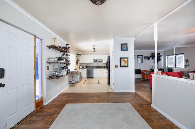 entryway with dark hardwood / wood-style floors and ornamental molding