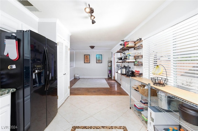 hallway featuring light wood-type flooring and ornamental molding