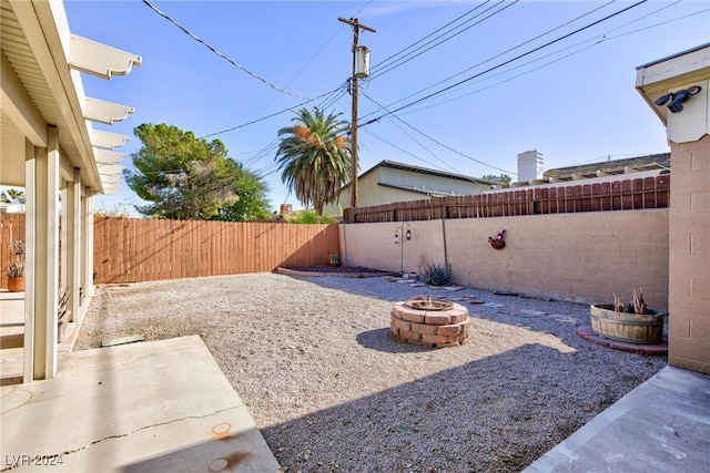 view of yard with a fire pit and a patio area