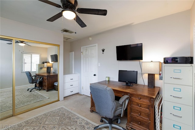 carpeted home office featuring ceiling fan