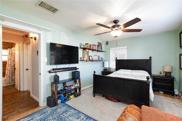 bedroom with ceiling fan and light wood-type flooring