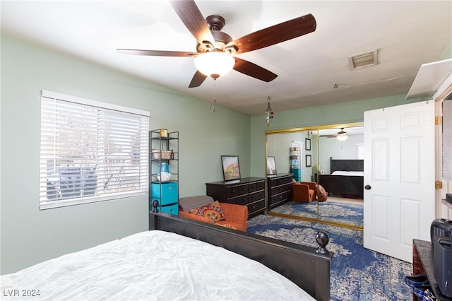 bedroom with ceiling fan and a closet