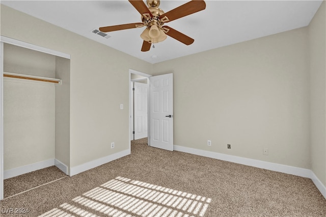 unfurnished bedroom with ceiling fan, a closet, and carpet floors