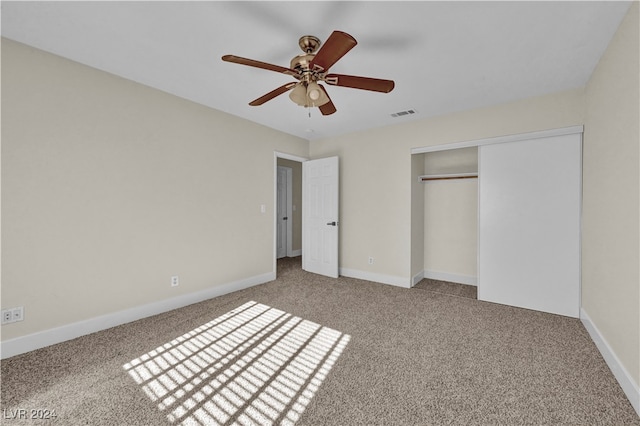 unfurnished bedroom with carpet floors, a closet, and ceiling fan