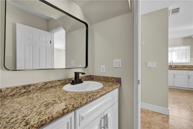 bathroom featuring tile patterned flooring and vanity