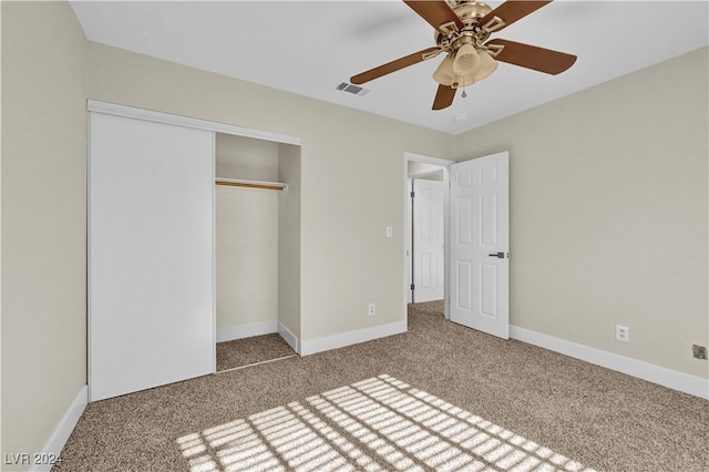 unfurnished bedroom featuring carpet flooring, ceiling fan, and a closet