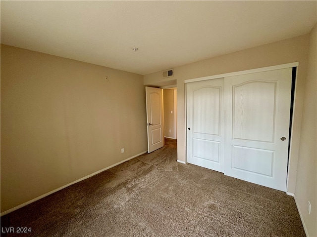 unfurnished bedroom featuring a closet and carpet