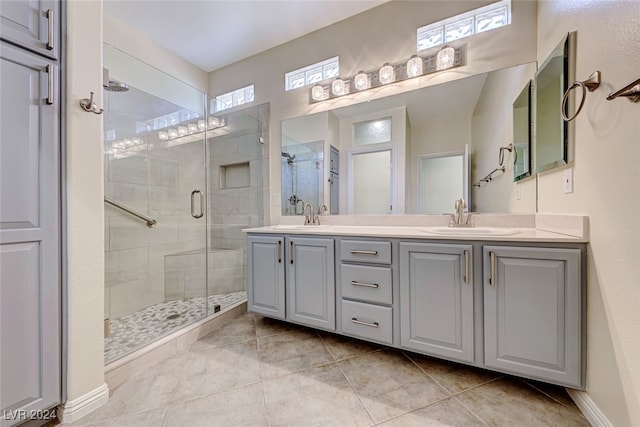 bathroom with vanity, tile patterned floors, walk in shower, and a healthy amount of sunlight