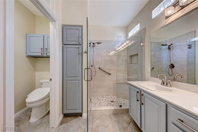 bathroom featuring vanity, an enclosed shower, and toilet