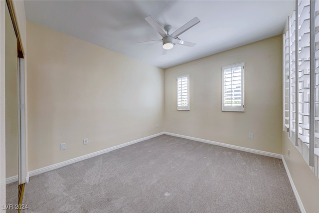 carpeted empty room featuring ceiling fan