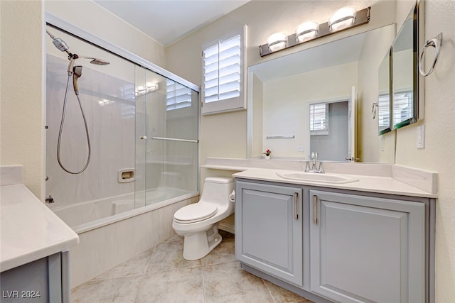 full bathroom with shower / bathing tub combination, vanity, a healthy amount of sunlight, and toilet