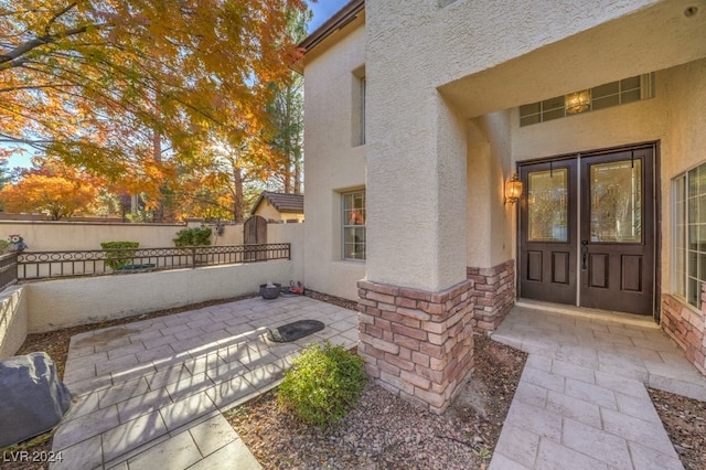 property entrance featuring a patio area