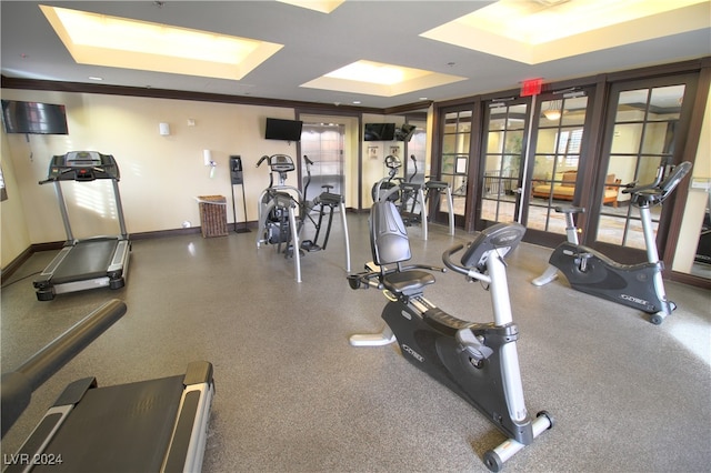 workout area with french doors, crown molding, and a tray ceiling