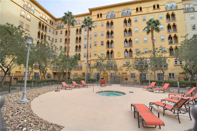 view of swimming pool with a hot tub