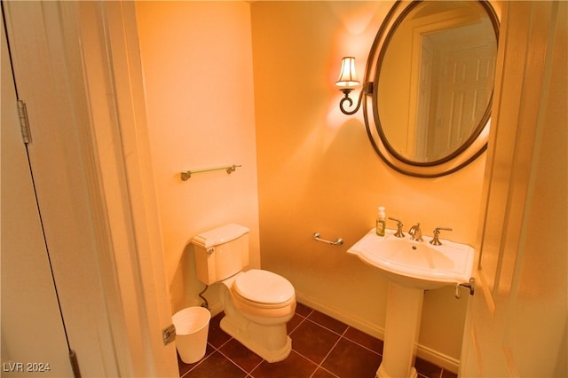 bathroom with tile patterned flooring, toilet, and sink