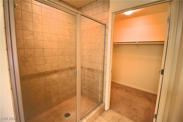 bathroom with tile patterned floors and an enclosed shower