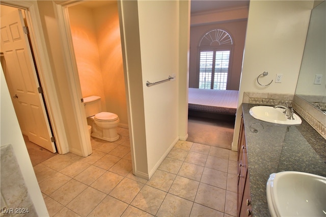 bathroom featuring tile patterned floors, vanity, toilet, and ornamental molding