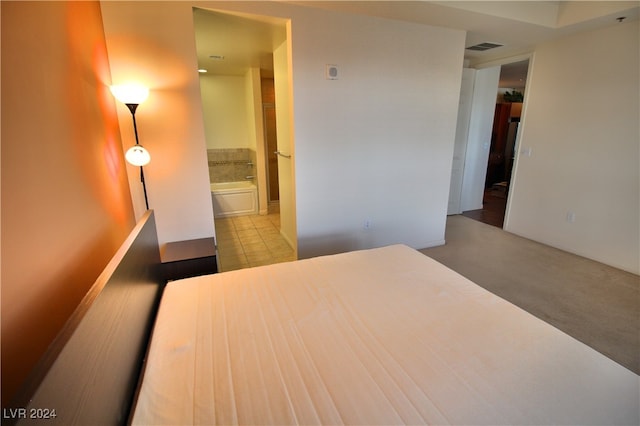 unfurnished bedroom featuring light tile patterned floors and ensuite bathroom