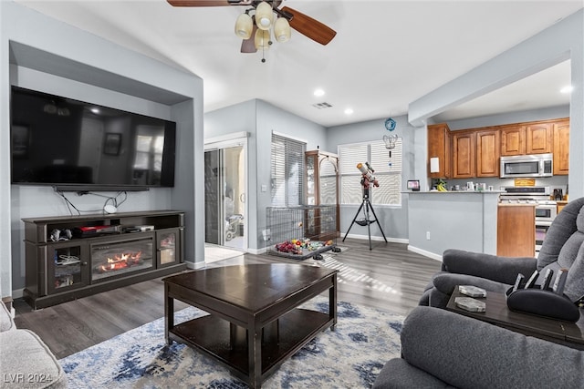 living room with dark hardwood / wood-style floors and ceiling fan