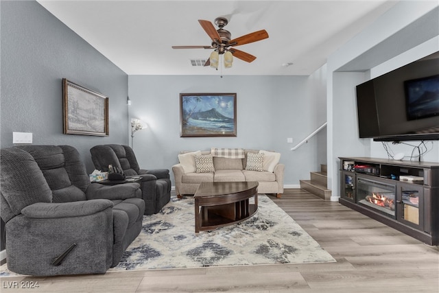 living room with light hardwood / wood-style floors and ceiling fan