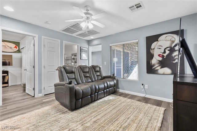 living room with ceiling fan and hardwood / wood-style flooring