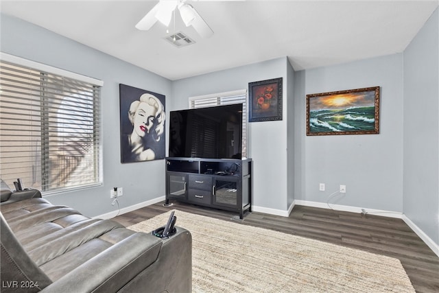 living room featuring dark hardwood / wood-style floors and ceiling fan