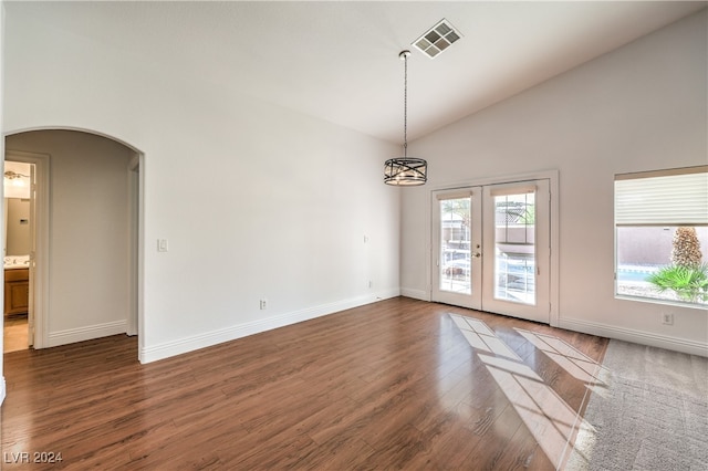 empty room with french doors, dark hardwood / wood-style flooring, and high vaulted ceiling