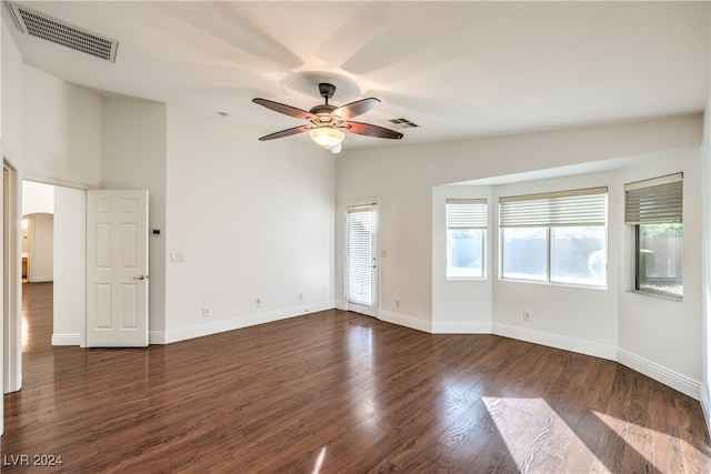 empty room with dark hardwood / wood-style floors and ceiling fan