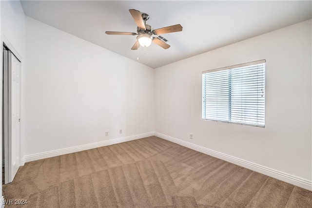 carpeted empty room with ceiling fan