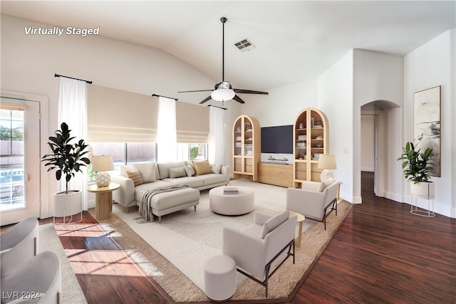 living room with ceiling fan, dark hardwood / wood-style flooring, and vaulted ceiling