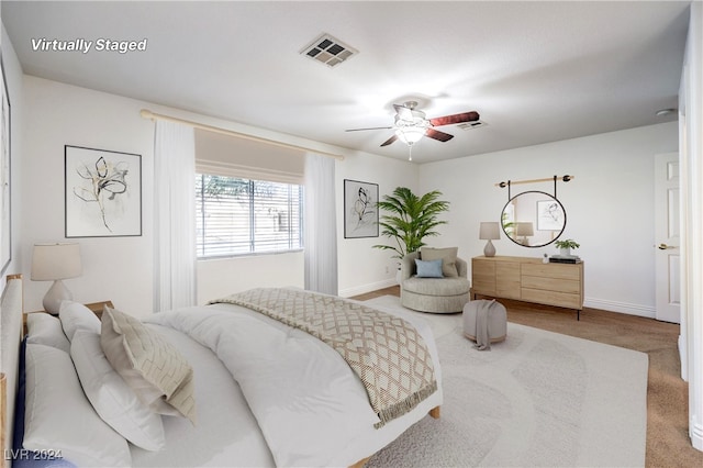 bedroom with ceiling fan and light colored carpet