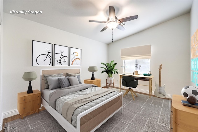 bedroom featuring dark colored carpet, vaulted ceiling, and ceiling fan