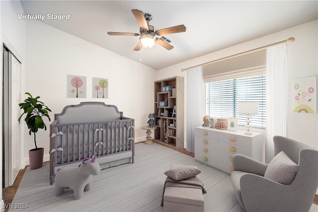 bedroom featuring a crib and ceiling fan