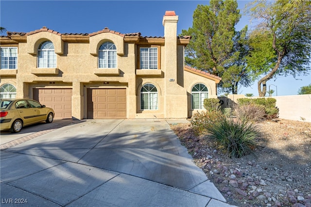 mediterranean / spanish-style home featuring a garage