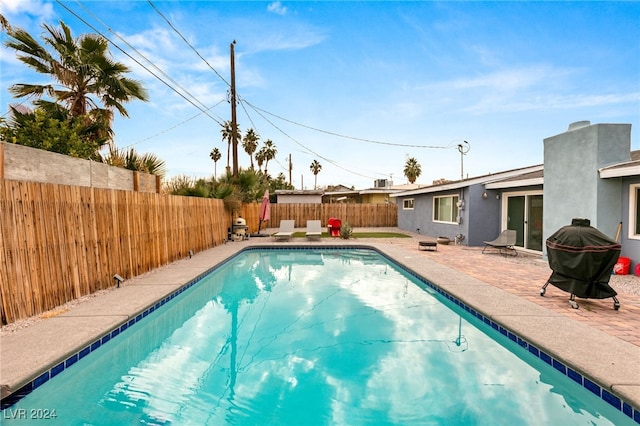 view of pool with a grill