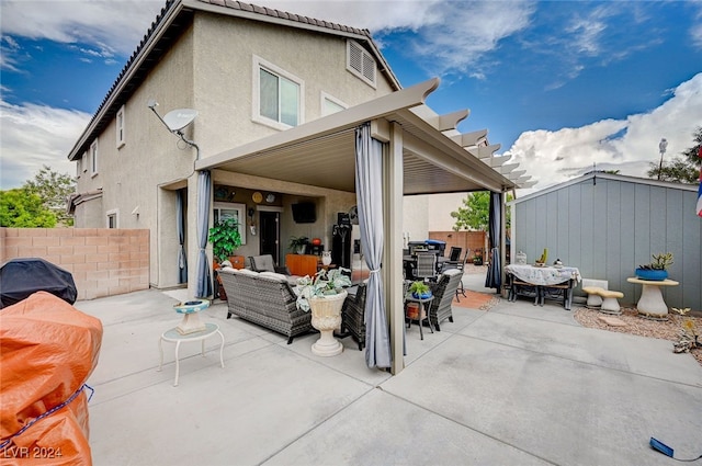 back of property with outdoor lounge area and a patio