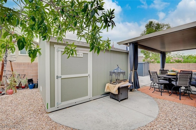 view of patio / terrace featuring a storage unit