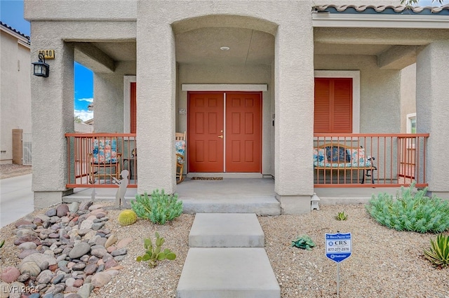 view of exterior entry featuring a porch