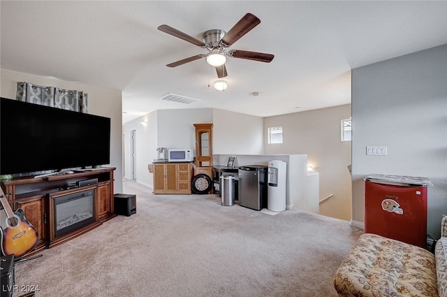 living room featuring light carpet and ceiling fan