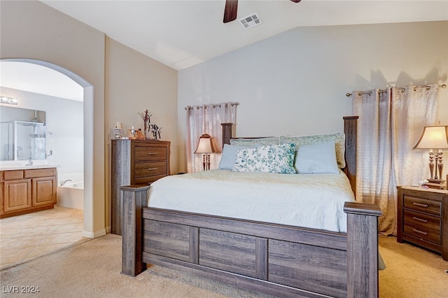 carpeted bedroom with connected bathroom, vaulted ceiling, ceiling fan, and sink