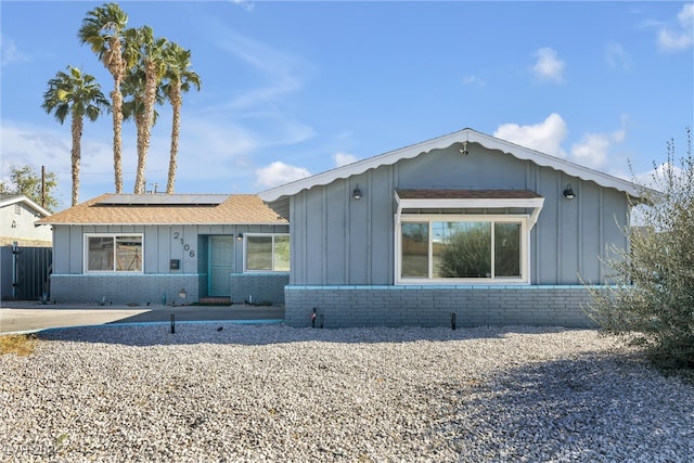 ranch-style home with solar panels