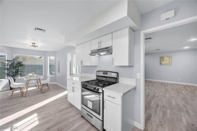 kitchen featuring white cabinets, light hardwood / wood-style flooring, and stainless steel range with gas stovetop