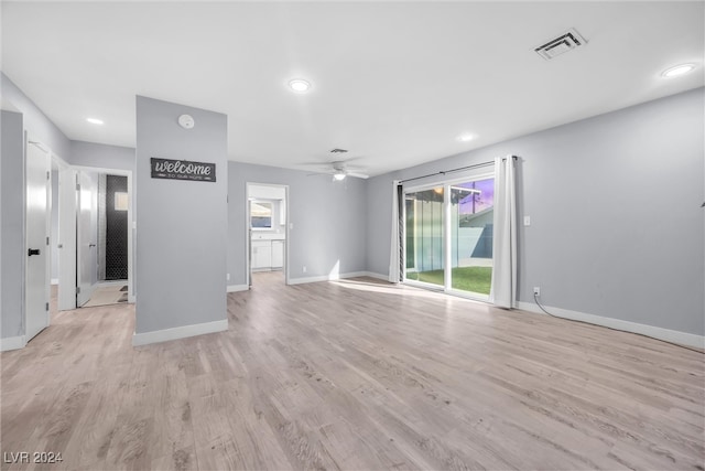 unfurnished living room with light wood-type flooring and ceiling fan