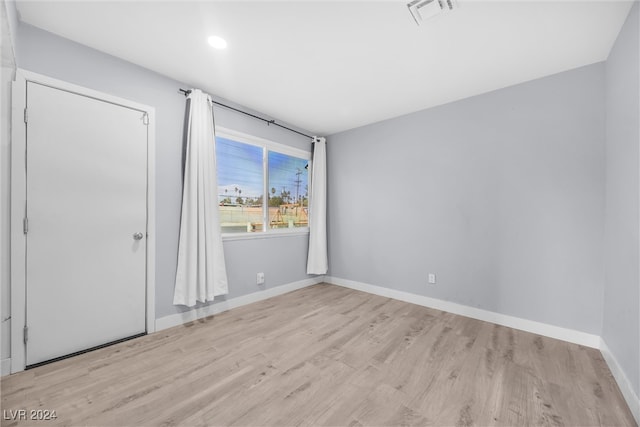 spare room with light hardwood / wood-style flooring