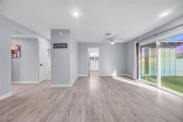 unfurnished living room featuring ceiling fan and light hardwood / wood-style floors